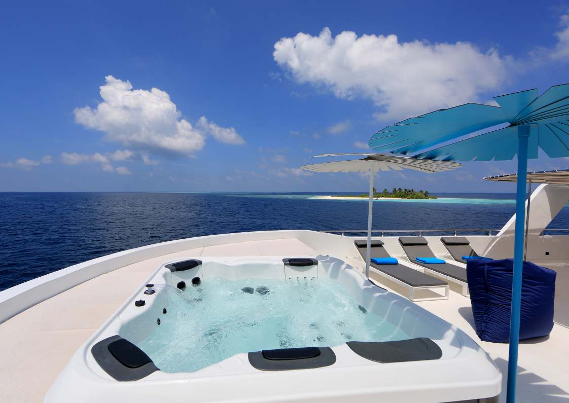 Sun deck jacuzzi and loungers aboard Azalea
